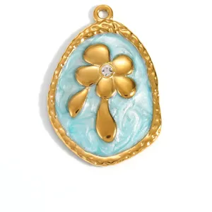 Close-up detail of a golden flower pendant with light blue enamel and central rhinestone