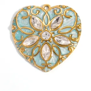 Macro detail of heart shaped gold plated pendant with light blue enamel and floral crystals