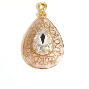 Detailed view of gold plated teardrop pendant with large clear crystal