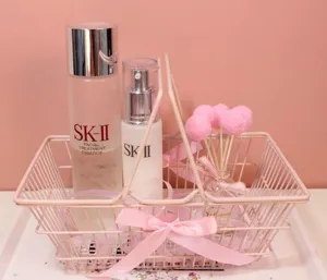Pink wire storage basket for desktop organization, cute student dorm decor and photo prop.