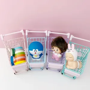 Detailed view of colorful miniature metal shopping carts displaying cute toy figurines nicely.