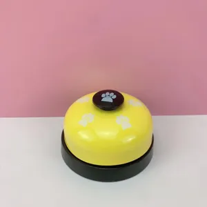 Yellow metal pet training bell with cute paw print details, perfect desk push bell for cats.