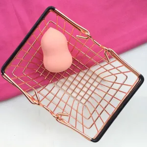 Mini metal shopping cart with pink beauty blender makeup sponge organizer desk decor prop.