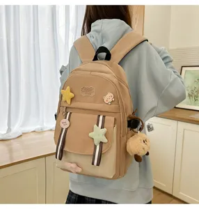 Modell trägt einen khaki Patchwork-Schulrucksack mit niedlicher Plüschstern-Deko