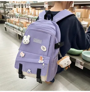 Vue détaillée d'un sac à dos patchwork violet et beige avec des pin's mignons