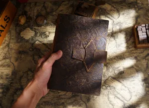 Handcrafted vintage cowhide leather A5 journal notebook with embossed floral pattern and buckle closure.