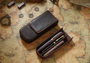 Detailed view of the brown leather pen case featuring 3 slots and magnetic closure.