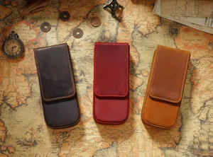 Detail view of vintage crazy horse leather pen pouches for three pens, magnetic closure design.