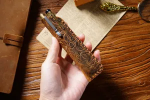 Handmade vintage genuine leather pen sleeve detail, showing exquisite floral embossing and soft texture.