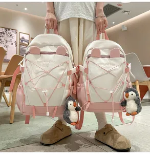 Zwei Größen pink-weiße Schulrucksäcke mit süßen Pinguin-Anhängern für Schülerinnen