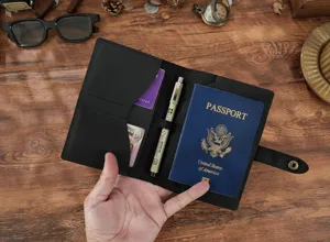 Black leather passport holder wallet travel document organizer with card slots and pen loop.