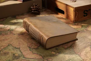 Handmade vintage leather journal notebook with rustic stitching, detailed close-up shot.