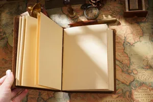Vintage handmade genuine leather notebook detail shot, classic blank pages for sketching.