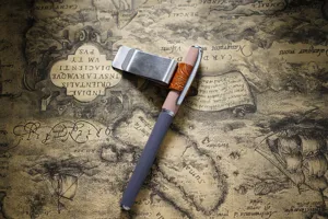 Detail view of a stylish vintage pen with a carved leather clip on an antique map background.