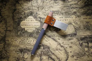 Metal pen holder and bookmark clip with embossed leather loop, vintage journal accessory.