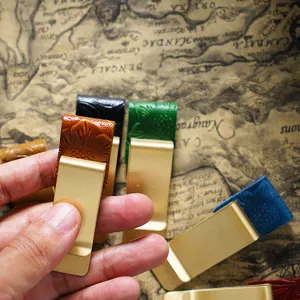 Brass metal money clip with embossed leather, vintage bookmark and pen holder accessory.