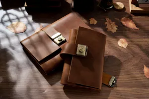 Vintage handmade genuine leather notebook with metal lock, retro diary journal for writing.