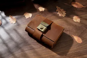 Vintage leather journal detail showcasing the exquisite brass lock and premium cowhide texture.