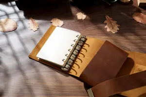 Handmade vintage leather loose-leaf notebook traveler diary sketch journal with metal rings detail.
