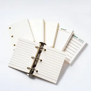 Mini 3-ring loose leaf refill detail view showing various page layouts like grid and lines.