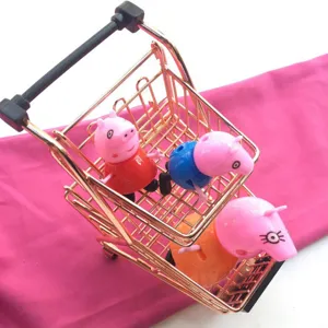 Mini metal shopping cart toy detail shot with cute cartoon pig figures for desktop decor.