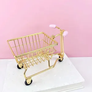 Gold iron mini tricycle desktop storage organizer detail view, cute pink handle accent.