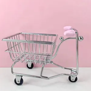 Mini metal shopping cart desktop organizer, cute three-wheel storage basket for home office decor.