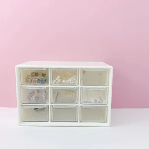 Clear 9-grid desktop storage box with transparent drawers for small items organization.