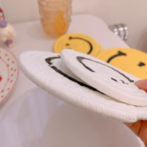 Ins style cute cartoon smiley face woven cotton coaster, heat insulation table mat for home decoration.