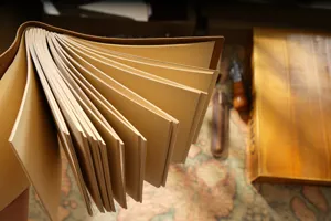 Handmade vintage genuine leather notebook detail, brown cowhide cover, kraft pages.