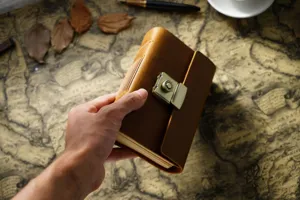 Nahaufnahme des handgefertigten Vintage Leder Notizbuchs mit Metall Zahlenschloss auf Karte.