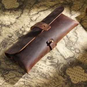 Vintage genuine leather pencil case with wrap strap and metal snap closure for school stationery.