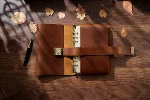 Vintage genuine leather loose-leaf notebook with brass combination lock, retro diary.