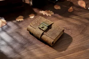 Vintage leather journal with combination lock and embossed floral design for travel writing.