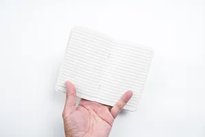 Vue détaillée des pages intérieures lignées du carnet, texture et lignes propres.
