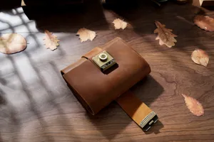 Close-up of vintage handmade genuine leather notebook with metal combination lock detail.