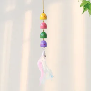 Cute multi-colored smiling bell wind chime hanging pendant with soft feather detail.
