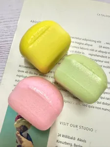 Close up of mini toast squeeze toys in pastel colors, slow rebound stress relief detail.