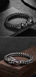 Macro detail of men's stainless steel dragon head bracelet with vintage braided chain.
