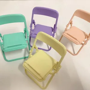 Close-up detail of cute macaron color mini folding chair phone stands in four colors.