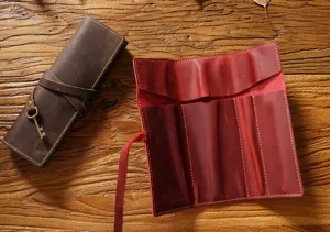 Genuine leather roll-up pencil pouch detail, vintage cowhide pen holder with slots and key charm.