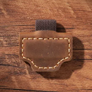 Close-up of vintage brown leather magnetic pen holder, showing fine stitching and elastic loop.
