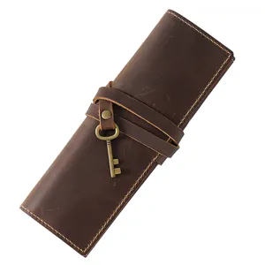 Vintage genuine leather roll-up pencil case brown retro cowhide pen bag for stationery storage.