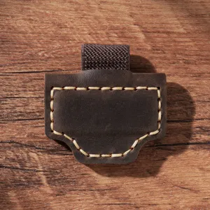 Detail shot of genuine leather magnetic pen holder with elastic loop and contrast stitching.