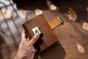 Vintage leather journal with combination lock, handmade retro traveler notebook for sketching.