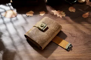 Vintage embossed leather journal with a mechanical combination lock for sketching and writing.