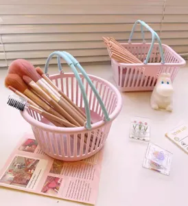 Cute miniature plastic desktop storage basket for stationery and cosmetics, detail view of pink design.