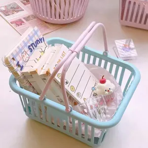 Cute pastel blue plastic desktop storage basket with pink handles, ideal for stationery.