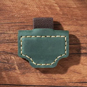 Close-up of green leather magnetic pen clip detail showcasing retro stitching and elastic band.