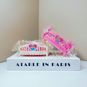 Mini dollhouse baby cradle bed toy, pink and white miniature bedroom furniture detail shot.